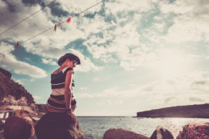 Loneliness and depression concept image with one young woman sit down alone at the beach Loneliness and depression concept image with one young woman sit down alone at the beach