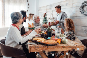 Family enjoy together christmas lunch at home - caucasian people have fun in friendship celebrating holidays and eve - white home and wooden style table Family enjoy together christmas lunch at home - caucasian people have fun in friendship celebrating holidays and eve - white home and wooden style table