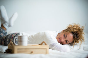 Beautiful adult woman have a nice relax at home or hotel room lay down on the bed ready to have breakfast and kake up - people in bedroom smile and enjoy the relaxed lifestyle Beautiful adult woman have a nice relax at home or hotel room lay down on the bed ready to have breakfast and kake up - people in bedroom smile and enjoy the relaxed lifestyle