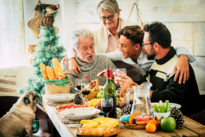 Cheerful caucasian family enjoy and celebrate together at home with table full of christmas decorations - mixed ages and generations from teenager to senior and adult have fun Cheerful caucasian family enjoy and celebrate together at home with table full of christmas decorations - mixed ages and generations from teenager to senior and adult have fun