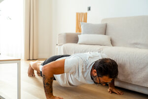 A 50-year-old man doing a fitness workout at home, including strength exercises with resistance bands, dumbbells, and flexibility training, focusing on body movement, balance, and maintaining a healthy lifestyle