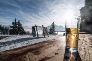 mountain landscape on the Tegelberg (mountain) in South Germany in winter, break on alpine hut, drink on a wooden table mountain landscape on the Tegelberg (mountain) in South Germany in winter, break on alpine hut, drink on a wooden table