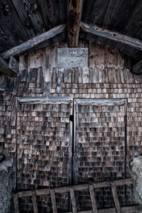Small hut with wooden shingles on the Tegelberg (mountain) in South Germany in winter, 