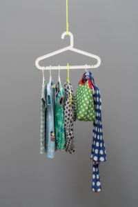 Wardrobe of hangers in front of grey wall in the old building,