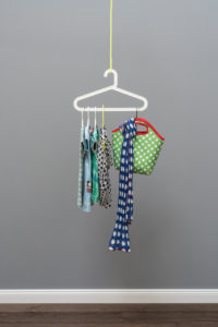 Wardrobe of hangers in front of grey wall in the old building,