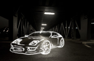 light drawing of a sports car on a bridge at night,