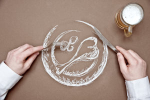 drawing of a meat dish, bird's-eye view, A person holds knife and fork over the plate,