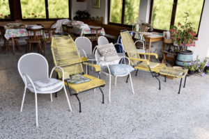 old garden chairs on a roofed terrace,