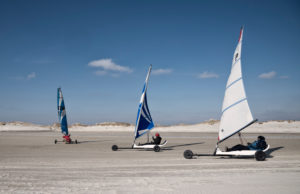 three beach sailer on the sandy beach sail with the wind