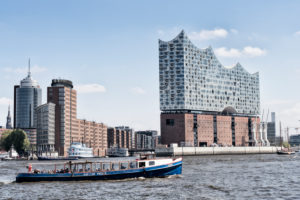 Elbphilharmonie seen from the water with sailboat and barge