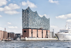 Elbphilharmonie seen from the water with sailboat and cruise ship