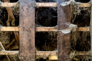 Hayloft of a farm covered with spider webs and straw