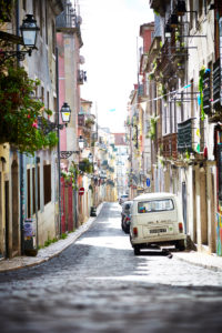 View along a street, alley in town, parking cars, Volkswagen Bus, Lisbon, Portugal View along a street, alley in town, parking cars, Volkswagen Bus, Lisbon, Portugal