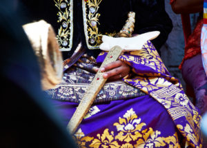 Bridegroom in festive clothing, sitting, close-up, sword, extravagantly decorated, gold, embroideries, reportage, traditional wedding, Bali, Indonesia, Asia Bridegroom in festive clothing, sitting, close-up, sword, extravagantly decorated, gold, embroideries, reportage, traditional wedding, Bali, Indonesia, Asia