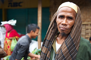 Man looking in the camera, friendly, market, Lombok, Indonesia, Asia Man looking in the camera, friendly, market, Lombok, Indonesia, Asia