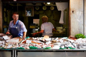 Market scene, fish stall, seller, fish, Venice Italy Market scene, fish stall, seller, fish, Venice Italy