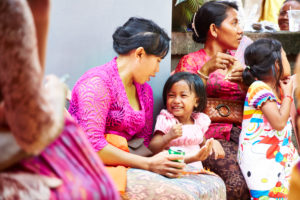 Mother playing with daughter, little girl laughing, reportage, traditional wedding, Bali, Indonesia, Asia Mother playing with daughter, little girl laughing, reportage, traditional wedding, Bali, Indonesia, Asia