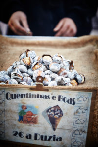 roasted sweet chestnuts, seller, cropped hands, Lisbon, Portugal roasted sweet chestnuts, seller, cropped hands, Lisbon, Portugal