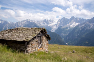 Old mountain hut over Soglio with Bergeller mountains in the background, region of Maloja, canton to Canton of Grisons, Switzerland Old mountain hut over Soglio with Bergeller mountains in the background, region of Maloja, canton to Canton of Grisons, Switzerland