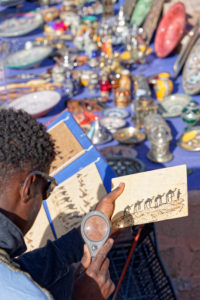 Ait Benhaddou, artist vendor, creative, Morocco, solar energy, power, commerce, young man, magnifying glass Ait Benhaddou, artist vendor, creative, Morocco, solar energy, power, commerce, young man, magnifying glass