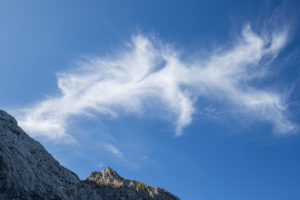Bizarre cloud formation against a blue sky and rock massif at Alpspitze, Garmisch-Partenkirchen, Upper Bavaria, Bavaria, southern Germany, Germany Bizarre cloud formation against a blue sky and rock massif at Alpspitze, Garmisch-Partenkirchen, Upper Bavaria, Bavaria, southern Germany, Germany