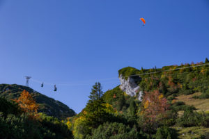 Paraglider near the Alpspitze against a blue sky over gondola, Hochalmbahn near Garmisch-Partenkirchen, Upper Bavaria, Bavaria, southern Germany, Germany Paraglider near the Alpspitze against a blue sky over gondola, Hochalmbahn near Garmisch-Partenkirchen, Upper Bavaria, Bavaria, southern Germany, Germany