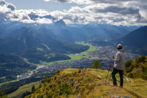 Man enjoys view from the Wank over Garmisch-Partenkirchen, view towards the Wetterstein Mountains with Alpspitze, Waxensteinen and Zugspitze and Berg Daniel (Austria), Garmisch-Partenkirchen, Upper Bavaria, Bavaria, southern Germany, Germany Man enjoys view from the Wank over Garmisch-Partenkirchen, view towards the Wetterstein Mountains with Alpspitze, Waxensteinen and Zugspitze and Berg Daniel (Austria), Garmisch-Partenkirchen, Upper Bavaria, Bavaria, southern Germany, Germany