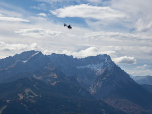 Helicopter over Wetterstein Mountains with Alpspitze, Jubiläumsgrat, Zugspitze, Höllental and Waxensteinen, blue sky, clouds, Garmisch-Partenkirchen, Upper Bavaria, Bavaria, Southern Germany, Germany Helicopter over Wetterstein Mountains with Alpspitze, Jubiläumsgrat, Zugspitze, Höllental and Waxensteinen, blue sky, clouds, Garmisch-Partenkirchen, Upper Bavaria, Bavaria, Southern Germany, Germany