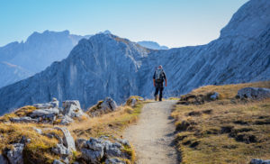 Man hiking at the foot of the Alpspitze with a view towards the Bernadeinkopf in the Wetterstein Mountains, blue sky, hiking trail, Garmisch-Partenkirchen, Upper Bavaria, Bavaria, southern Germany, Germany Man hiking at the foot of the Alpspitze with a view towards the Bernadeinkopf in the Wetterstein Mountains, blue sky, hiking trail, Garmisch-Partenkirchen, Upper Bavaria, Bavaria, southern Germany, Germany