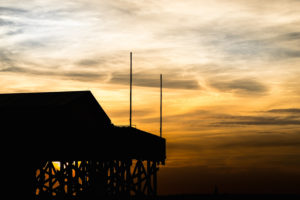 Colorful sunset on the North Sea - in the backlight of the sun a typical stilt house, pile dwellings, pile dwellings that defy the tides. Colorful sunset on the North Sea - in the backlight of the sun a typical stilt house, pile dwellings, pile dwellings that defy the tides.
