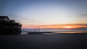 Colorful sunset on the North Sea - in the backlight of the sun a typical stilt house, pile dwellings, pile dwellings that defy the tides. Colorful sunset on the North Sea - in the backlight of the sun a typical stilt house, pile dwellings, pile dwellings that defy the tides.