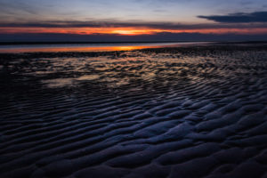 Relaxation on the Wadden Sea and on the beach of St. Peter Ording, North Sea at sunset. Relaxation on the Wadden Sea and on the beach of St. Peter Ording, North Sea at sunset.