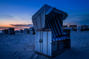 Relaxation in a beach chair. The North Sea at sunset. Wadden Sea and Beach Relaxation in a beach chair. The North Sea at sunset. Wadden Sea and Beach