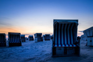 Relaxation in a beach chair. The North Sea at sunset. Wadden Sea and Beach, Blue Hour Relaxation in a beach chair. The North Sea at sunset. Wadden Sea and Beach, Blue Hour
