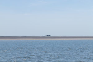 Solitude and tides - houses in the Wadden Sea, North Sea Solitude and tides - houses in the Wadden Sea, North Sea