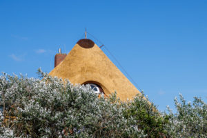 A thatched roof with a lightning rod.