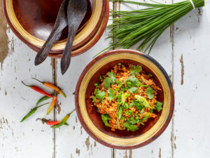 Ayurvedic cuisine - lentil salad in clay dishes, with chives and chilli pods