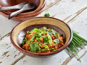 Ayurvedic cuisine - lentil salad in clay dishes, with a bunch of chives