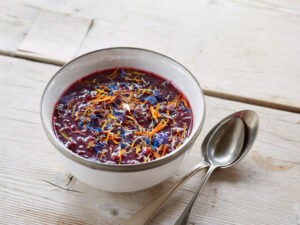 ayurvedic cuisine, chutney of dark fruits in a light bowl on light wooden table