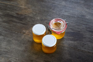 ayurvedic diet, steps to prepare homemade ghee from butter - filtered, still liquid ghee in three storage jars.