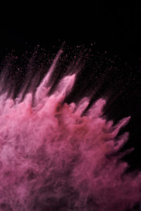 Red powder, explosion, black background Red powder, explosion, black background