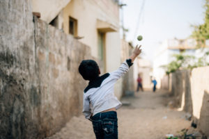 A boy while playing with the ball in a village in the Rann of Kutch in Gujarat, India A boy while playing with the ball in a village in the Rann of Kutch in Gujarat, India