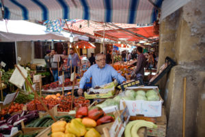 Seller with cigarette at a market in Palermo, Sicily Seller with cigarette at a market in Palermo, Sicily