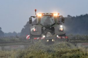 Harvest time, combine at twilight Harvest time, combine at twilight