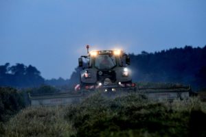 Harvest time, combine at twilight Harvest time, combine at twilight