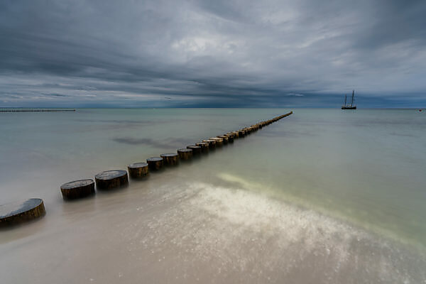 Traditional german fishing boat on the beach of Baltic sea in the sunset  before storm. Picture