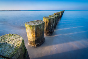 Breakwaters on the Baltic Sea in the evening light and long exposure Breakwaters on the Baltic Sea in the evening light and long exposure