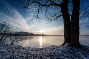 Sunrise over the lake in winter with drifting clouds Sunrise over the lake in winter with drifting clouds