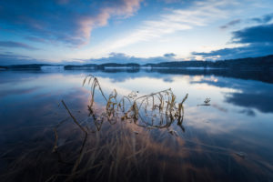Sunrise over the lake in winter with drifting clouds Sunrise over the lake in winter with drifting clouds