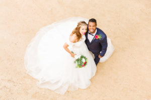 Wedding, newlyweds, young adults, diversity, love, sand, bird's eye view Wedding, newlyweds, young adults, diversity, love, sand, bird's eye view